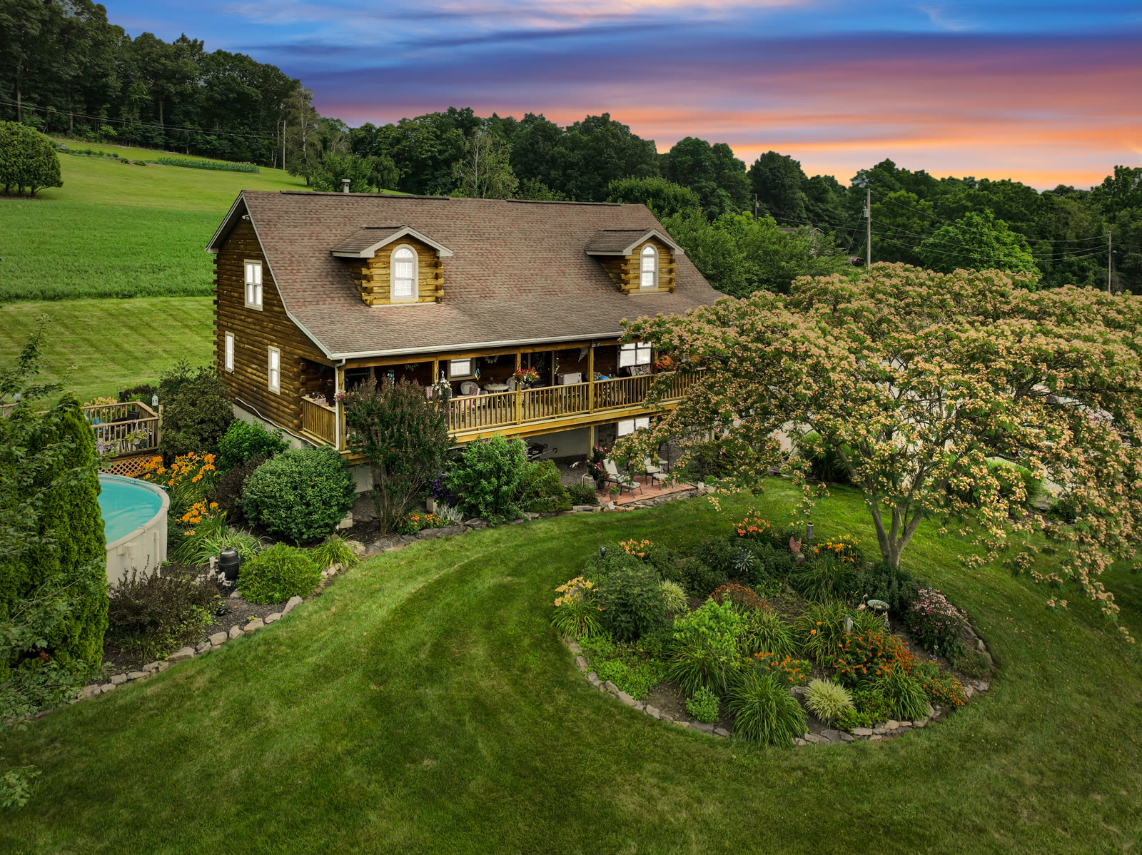 Twilight drone photo of a Central PA home with landscaped gardens
